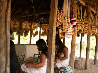 Visitors traveling by boat to the Kogui community in the Sierra Nevada de Santa Marta